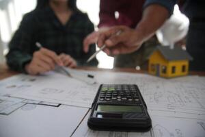 Diverse Team of Specialists Use Laptop on Construction Site. Real Estate Building Project with Engineer Investor and Businessman Checking Area, working on Civil Engineering, Discussing Strategy Plan photo