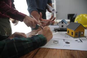 Diverse Team of Specialists Use Laptop on Construction Site. Real Estate Building Project with Engineer Investor and Businessman Checking Area, working on Civil Engineering, Discussing Strategy Plan photo