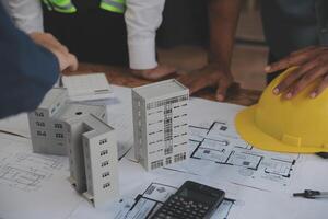 Construction and structure concept of Engineer or architect meeting for project working with partner and engineering tools on model building and blueprint in working site, contract for both companies. photo