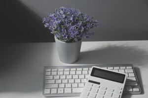 Calculator on a dark background, plastic cards and banknotes photo