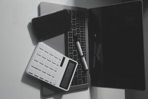 Office leather desk table with calculator and pen. Top view with copy space photo