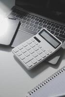 Office leather desk table with calculator and pen. Top view with copy space photo