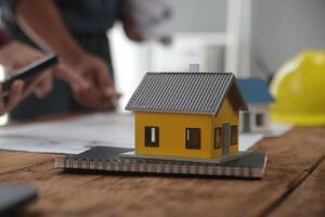 Diverse Team of Specialists Use Laptop on Construction Site. Real Estate Building Project with Engineer Investor and Businessman Checking Area, working on Civil Engineering, Discussing Strategy Plan photo