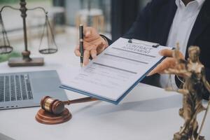 Business and lawyers discussing contract papers with brass scale on desk in office. Law, legal services, advice, justice and law concept picture with film grain effect photo