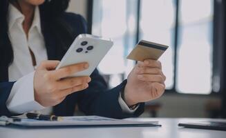 Women holding credit card and using smartphones at home.Online shopping, internet banking, store online, payment, spending money, e-commerce payment at the store, credit card, concept photo