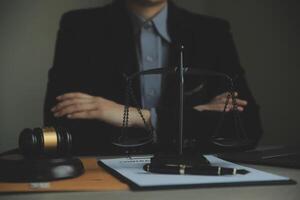 Business and lawyers discussing contract papers with brass scale on desk in office. Law, legal services, advice, justice and law concept picture with film grain effect photo