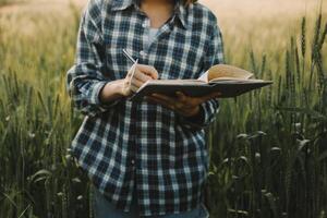 Smart farm. Farmer with tablet in the field. Agriculture, gardening or ecology concept. Harvesting. Agro business. photo