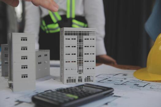 Construction and structure concept of Engineer or architect meeting for project working with partner and engineering tools on model building and blueprint in working site, contract for both companies. photo