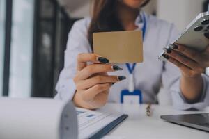 Women holding credit card and using smartphones at home.Online shopping, internet banking, store online, payment, spending money, e-commerce payment at the store, credit card, concept photo