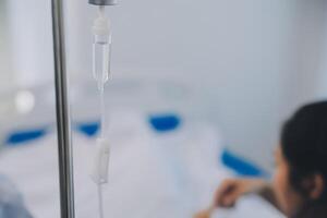 Asian Doctor make routine health check with patient in hospital ward photo