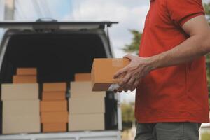 Asian delivery express courier young man use giving boxes to woman customer he wearing protective face mask at front home photo