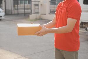 Asian delivery express courier young man use giving boxes to woman customer he wearing protective face mask at front home photo