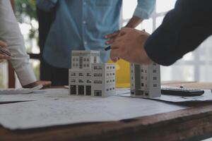 Construction and structure concept of Engineer or architect meeting for project working with partner and engineering tools on model building and blueprint in working site, contract for both companies. photo