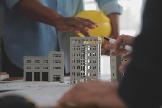 Construction and structure concept of Engineer or architect meeting for project working with partner and engineering tools on model building and blueprint in working site, contract for both companies. photo