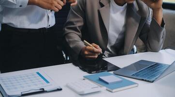 Young stressed Asian businessman working in the office. Businessman thinking too much work concept in the office. photo