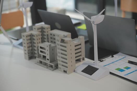 Close-up at tablet, Engineers pointing at tablet with their hands. To jointly design the use of renewable energy with wind and solar energy. Concept of using renewable energy. photo