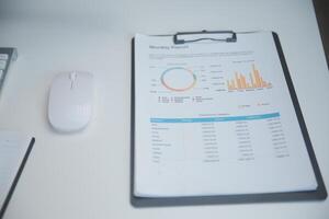 Laptop and paperwork on conference table photo