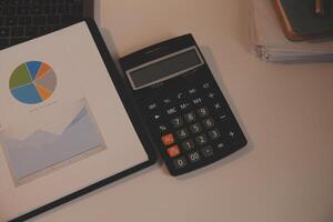 Laptop and paperwork on conference table photo