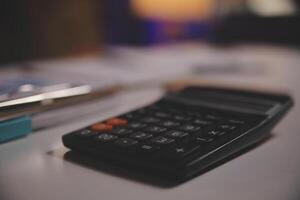 Business woman using calculator for do math finance on wooden desk in office and business working background, tax, accounting, statistics and analytic research concept photo