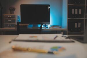 Laptop and paperwork on conference table photo