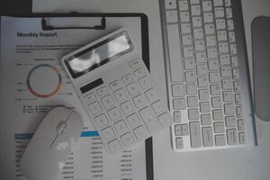 Laptop and paperwork on conference table photo