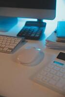 Laptop and paperwork on conference table photo