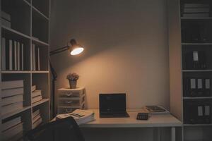 Laptop and paperwork on conference table photo