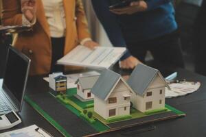 Team of architectures and businessmen discussing and brainstorming on floor plan modification for real estate investment and housing development project photo