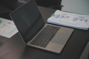 Laptop on a desk in an open financial office. photo