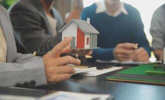 Team of architectures and businessmen discussing and brainstorming on floor plan modification for real estate investment and housing development project photo