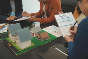 Team of architectures and businessmen discussing and brainstorming on floor plan modification for real estate investment and housing development project photo