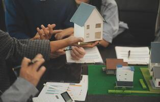 Team of architectures and businessmen discussing and brainstorming on floor plan modification for real estate investment and housing development project photo