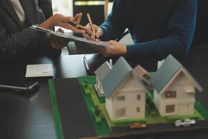 Team of architectures and businessmen discussing and brainstorming on floor plan modification for real estate investment and housing development project photo