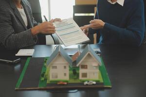 Team of architectures and businessmen discussing and brainstorming on floor plan modification for real estate investment and housing development project photo