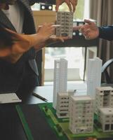 Team of architectures and businessmen discussing and brainstorming on floor plan modification for real estate investment and housing development project photo