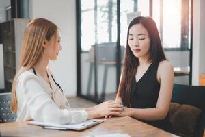 Employee receives a consultation from a healthcare professional, discussing health matters in a modern office environment. photo