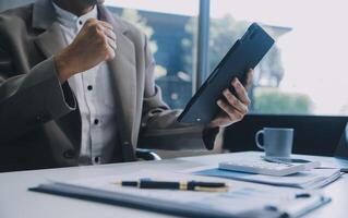 Office, tablet and business man happy for positive financial savings, finance budget report or administration feedback. Growth analytics, data analysis review and person smile for research statistics photo