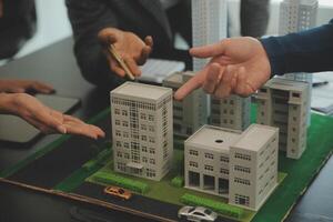 Team of architectures and businessmen discussing and brainstorming on floor plan modification for real estate investment and housing development project photo