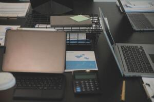 Laptop on a desk in an open financial office. photo