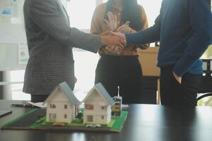 Team of architectures and businessmen discussing and brainstorming on floor plan modification for real estate investment and housing development project photo