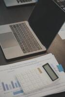 Laptop on a desk in an open financial office. photo
