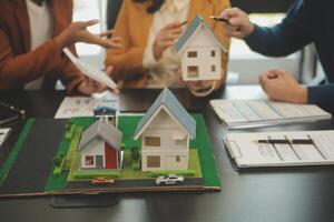 Team of architectures and businessmen discussing and brainstorming on floor plan modification for real estate investment and housing development project photo