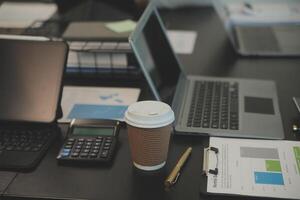 Laptop on a desk in an open financial office. photo