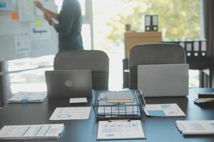 Laptop on a desk in an open financial office. photo