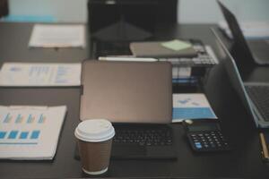 Laptop on a desk in an open financial office. photo