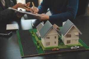 Team of architectures and businessmen discussing and brainstorming on floor plan modification for real estate investment and housing development project photo