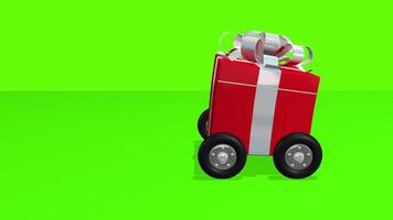 Red gift box with silver ribbon on wheels moves from left to right against green background. 3D animation video