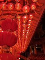 Illuminated Red Lanterns Adorn Traditional Architecture photo