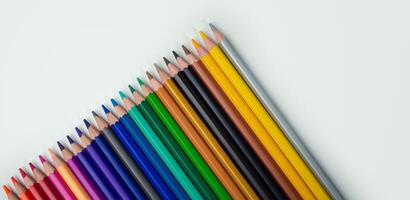 Set of colored pencils on a white background That is arranged in a bar graph, Color pencils on white background, Close up, seamless colored pencils row with wave on lower side, line pencils. photo