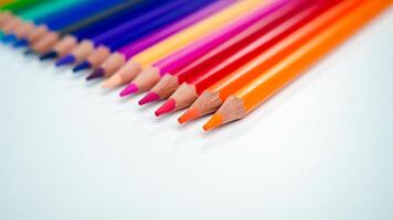 Set of colored pencils on a white background That is arranged in a bar graph, Color pencils on white background, Close up, seamless colored pencils row with wave on lower side, line pencils. photo